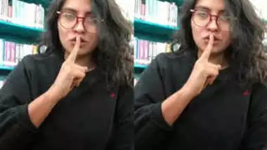 Desi sex student pulls T-shirt up to demonstrate XXX breasts in a library