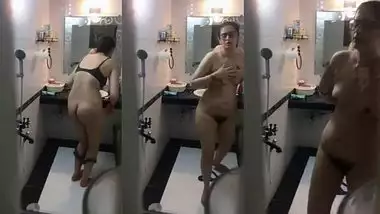 Nerdy Desi woman washes her XXX curves in shower not noticing camera