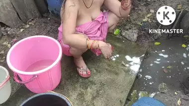 Indian house wife bathing outside