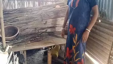 Bihari babu pounds his malkin outdoors in a hut